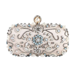 Designer metal clutch bridal chain bag in elegant gold finish with structured silhouette, polished metallic surface, and detachable chain strap, perfect for weddings, evening parties, and formal occasions.