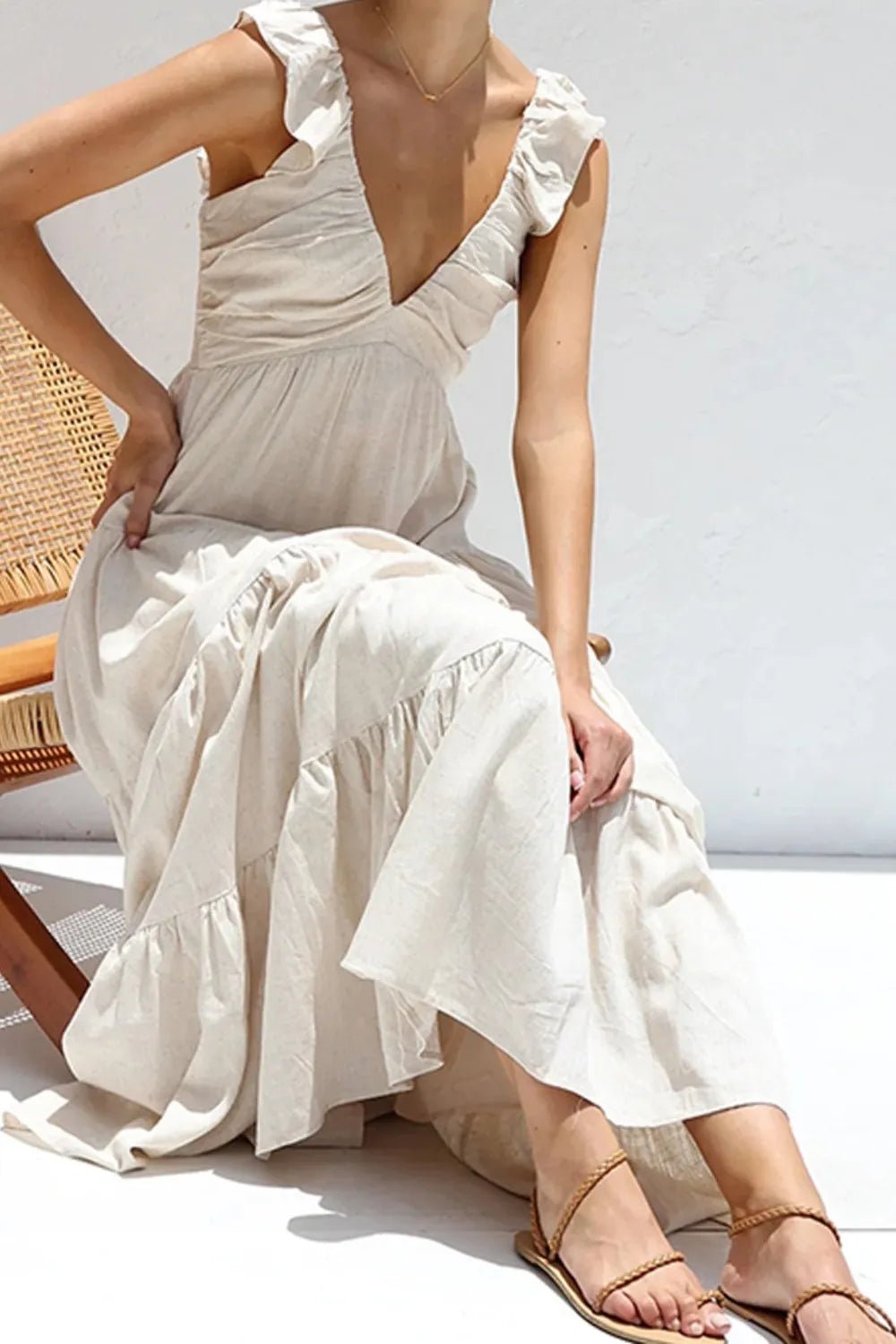 Ivory tiered cotton maxi dress with ruffled shoulders and flowing romantic silhouette.