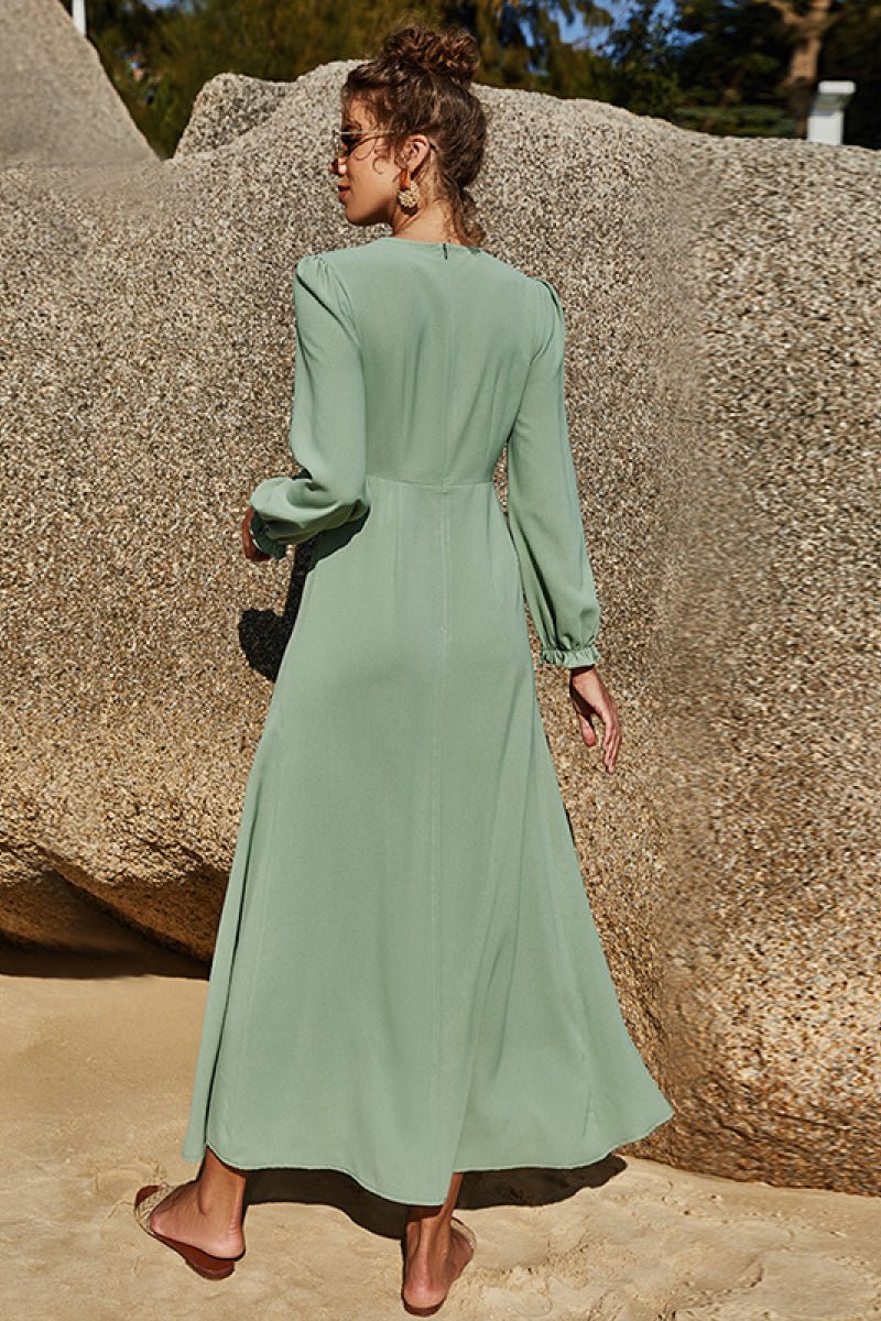 Soft sage floral maxi dress with puff sleeves and flowing skirt styled outdoors.