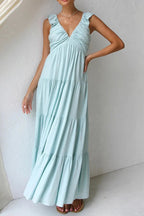Ivory tiered cotton maxi dress with ruffled shoulders and flowing romantic silhouette.