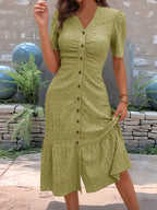 Sage green embroidered midi dress with button-front detail and feminine ruffle hem.