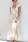Ivory tiered cotton maxi dress with ruffled shoulders and flowing romantic silhouette.
