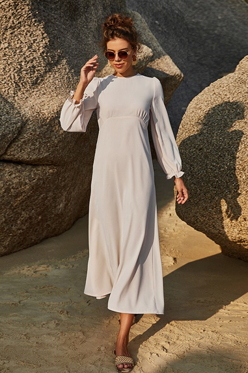 Soft sage floral maxi dress with puff sleeves and flowing skirt styled outdoors.