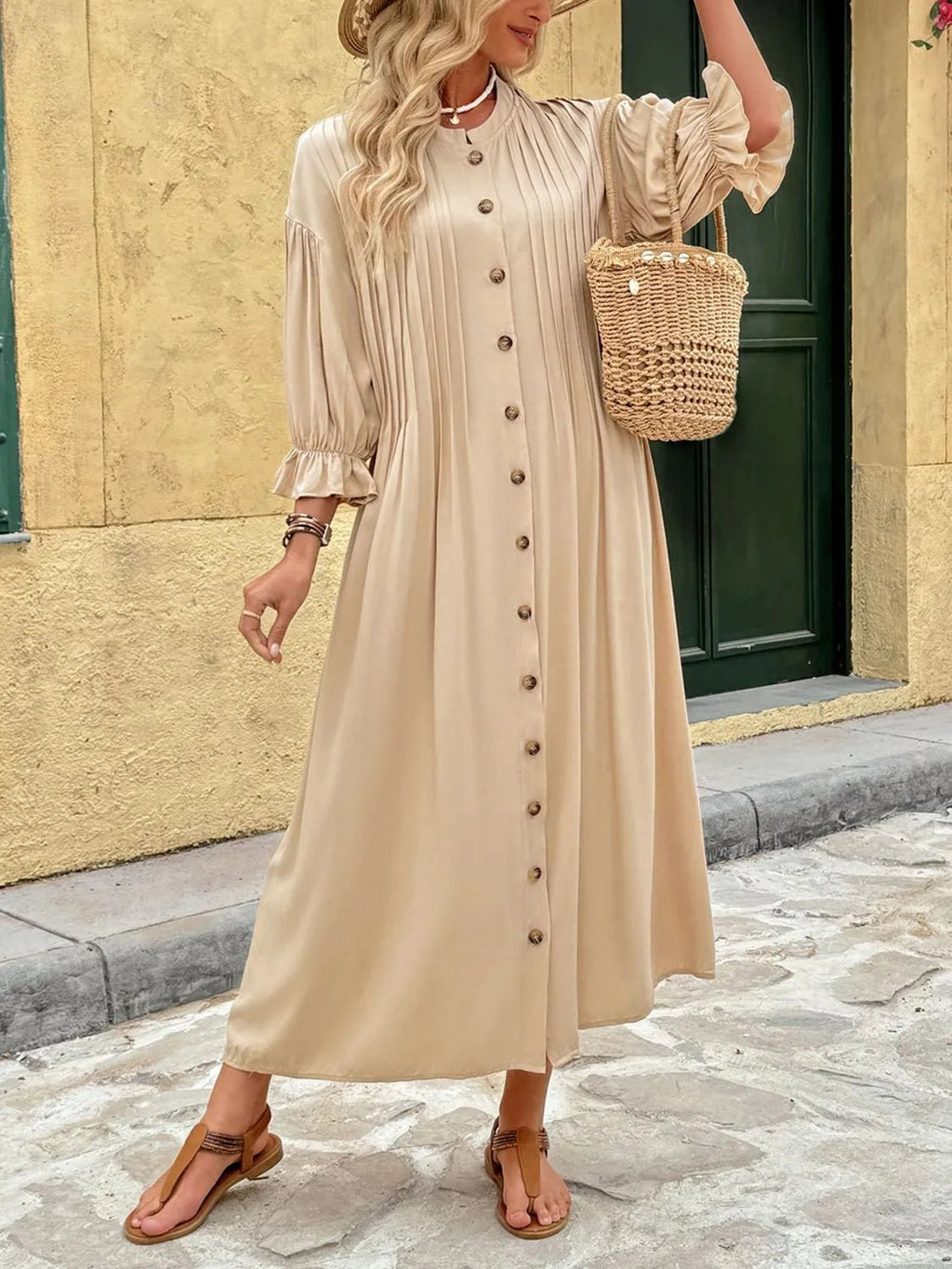 Elegant beige button-front maxi dress with long sleeves and flowing silhouette.