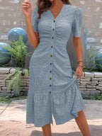 Sage green embroidered midi dress with button-front detail and feminine ruffle hem.