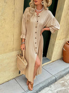 Elegant beige button-front maxi dress with long sleeves and flowing silhouette.
