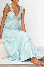 Ivory tiered cotton maxi dress with ruffled shoulders and flowing romantic silhouette.