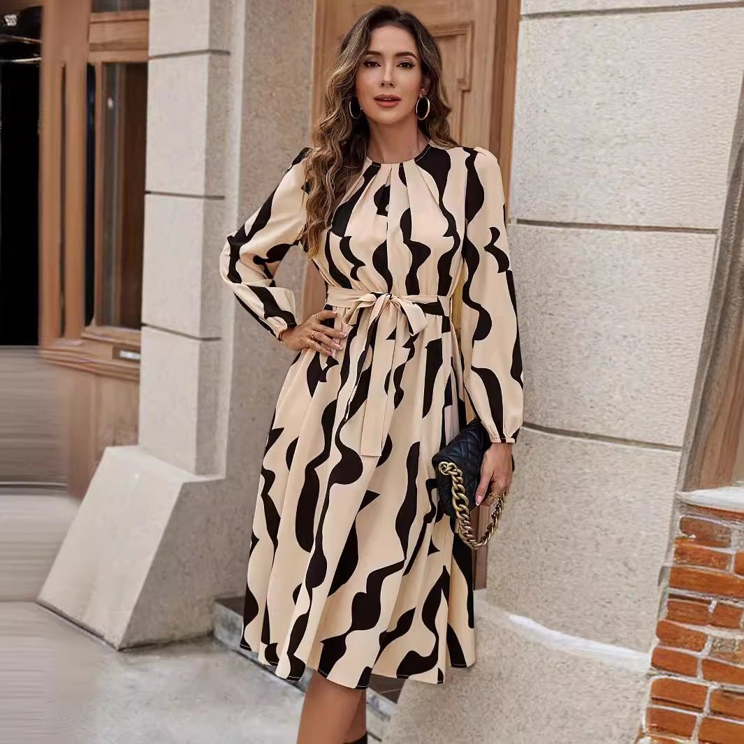 Elegant printed midi dress with tied waist detail and feminine design