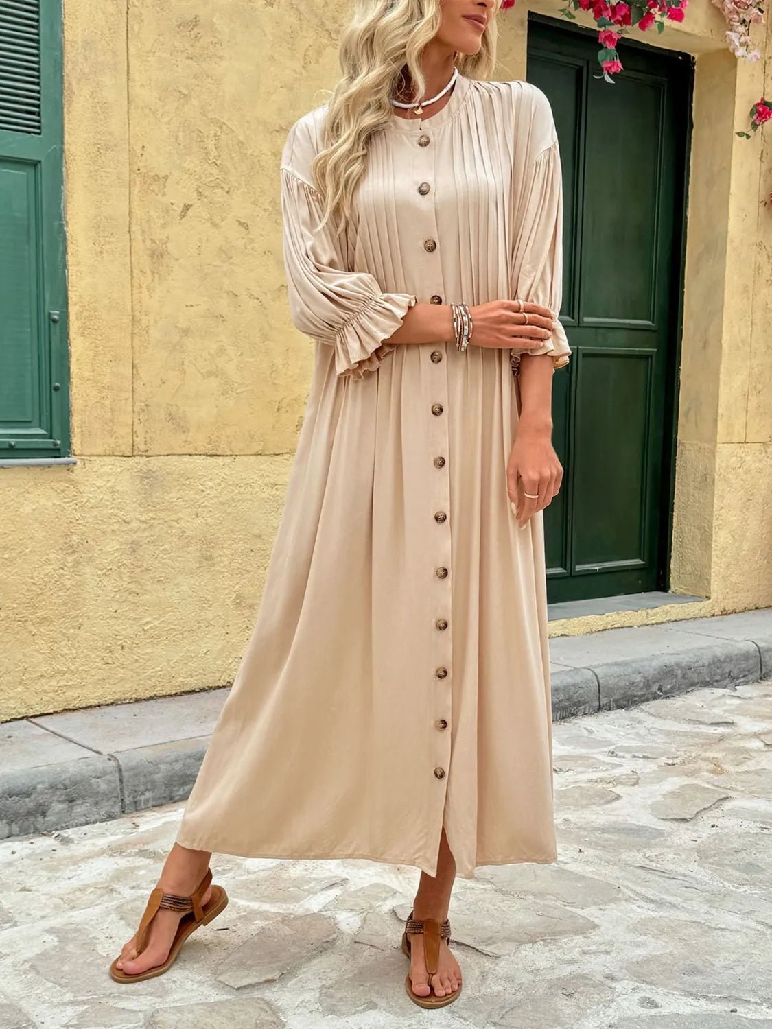 Elegant beige button-front maxi dress with long sleeves and flowing silhouette.