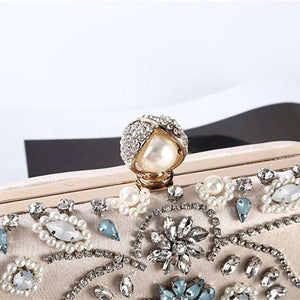 Designer metal clutch bridal chain bag in elegant gold finish with structured silhouette, polished metallic surface, and detachable chain strap, perfect for weddings, evening parties, and formal occasions.