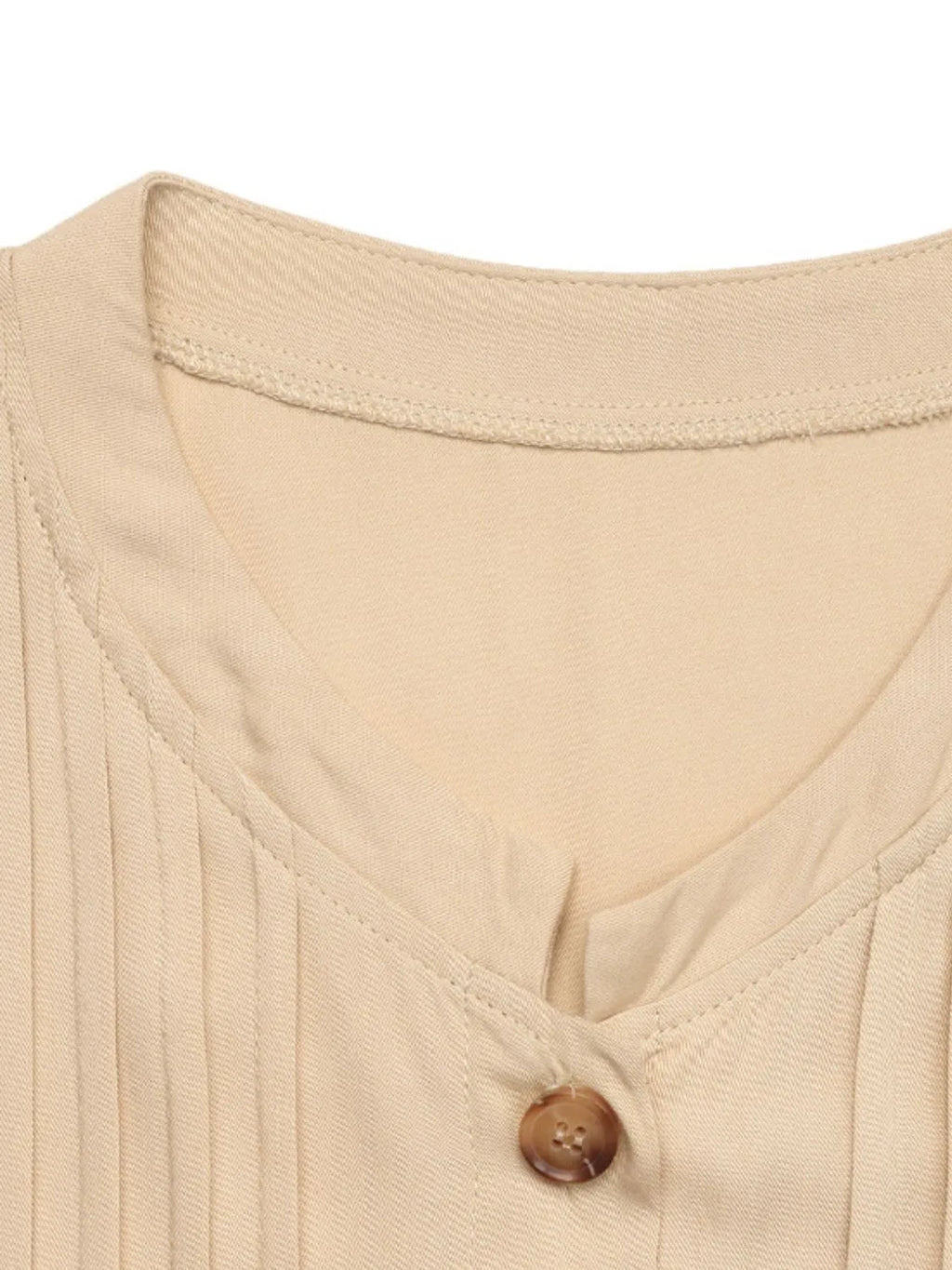 Elegant beige button-front maxi dress with long sleeves and flowing silhouette.