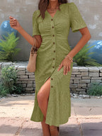 Sage green embroidered midi dress with button-front detail and feminine ruffle hem.